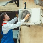 hvac-technician-working-capacitor-part-condensing-unit-male-worker-repairman-uniform-repairing-adjusting-conditioning-system-diagnosing-looking-technical-issues-min-scaled.jpg
